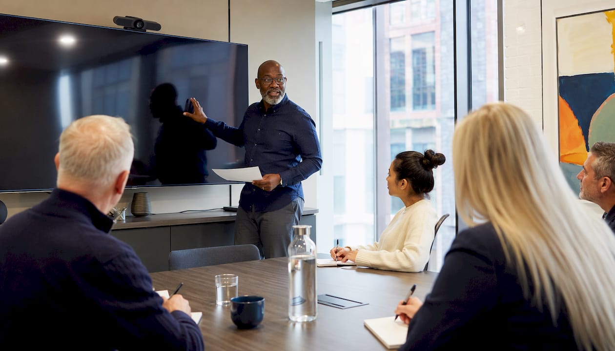 Sales trainer delivering class in UK office