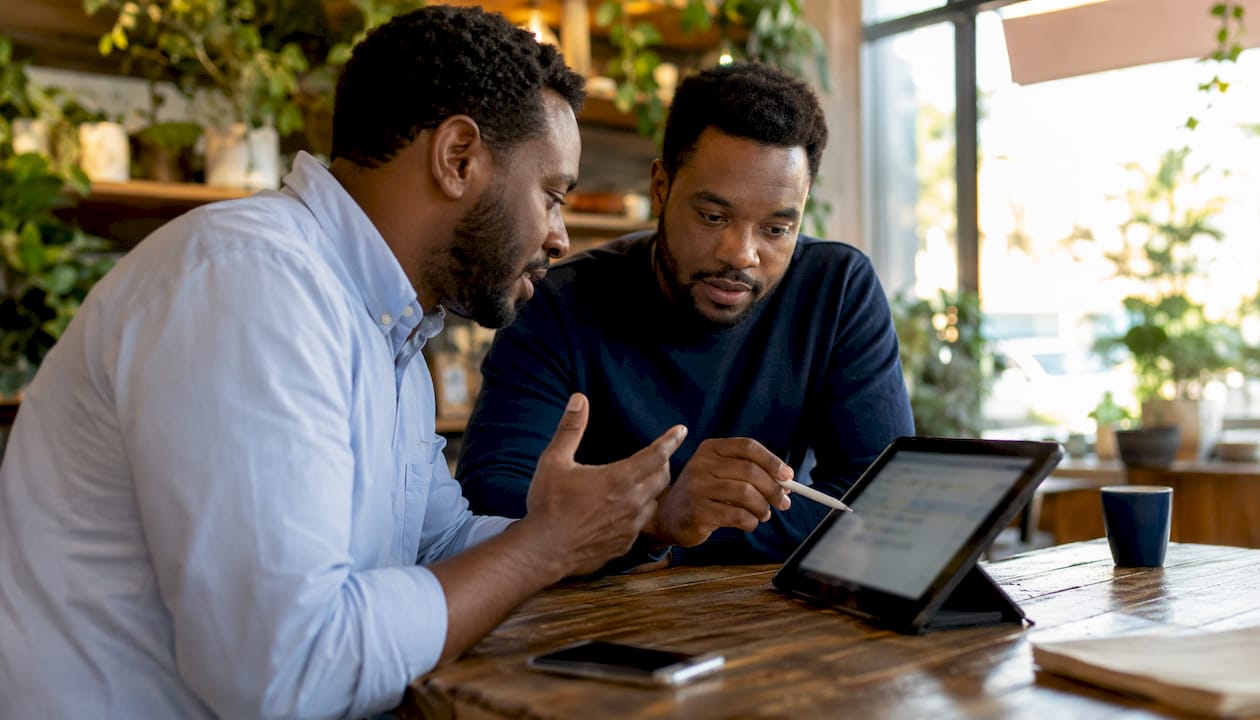 Two men discussing field service scheduling app