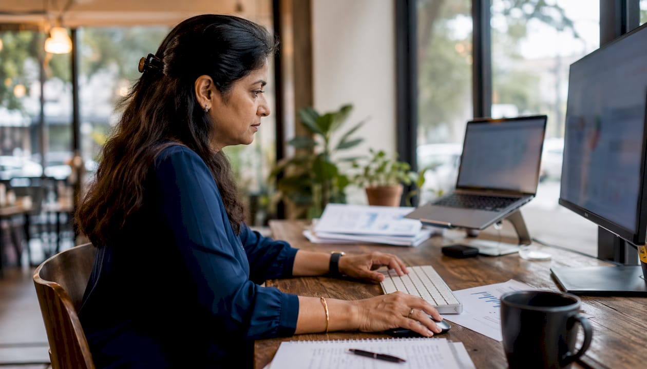 Hands using sales tech equipment in office setup