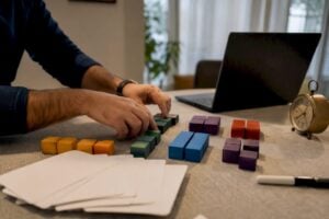 Hands assembling sales training materials