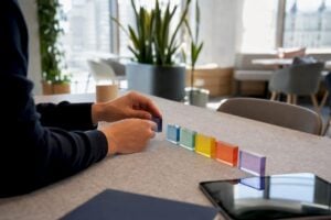 Hands arranging sales process stage blocks