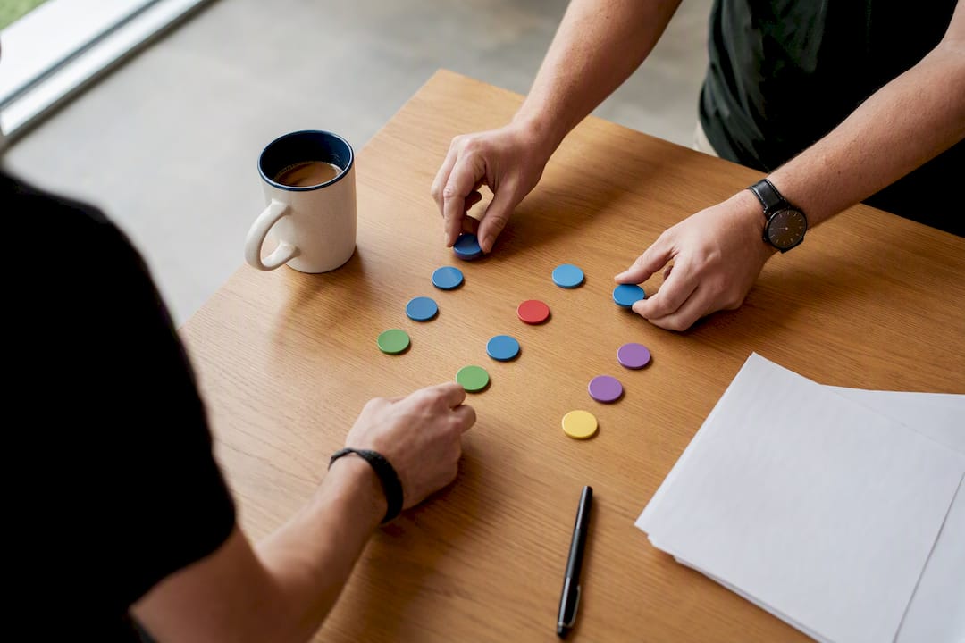 Hands arranging buying committee role tokens