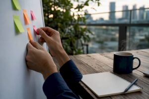 Hands arranging sticky notes for sales planning