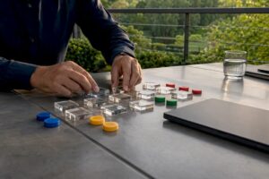 Hands arranging sales measurement tokens
