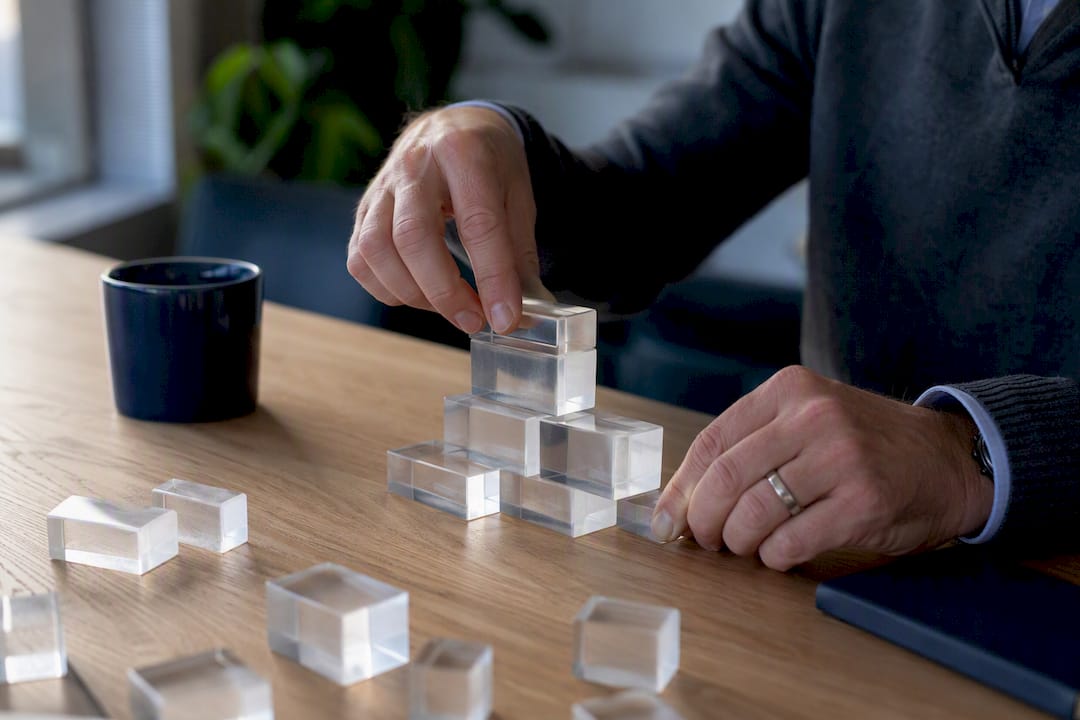Hands assembling consultative sales coaching blocks