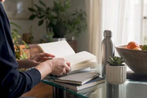 Hands selecting sales books on desk