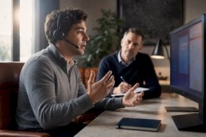 Sales rep practising with human coach nearby