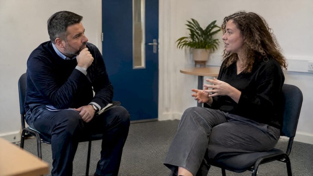 Manager coaching representative during sales rehearsal