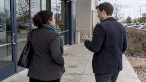 Sales leader coaching a new rep after a visit