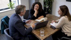 Business owner comparing sales consulting and coaching